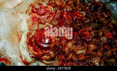 Homemade red tasty apple pie on a dark stove background in parchment butter paper Stock Photo