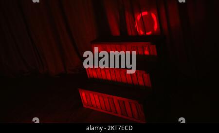 Red night LED lighting wooden stairs on the stage of theatre and red link background Stock Photo