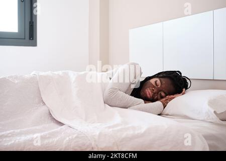 Relaxed woman with vitiligo lying in bed sleeping Stock Photo