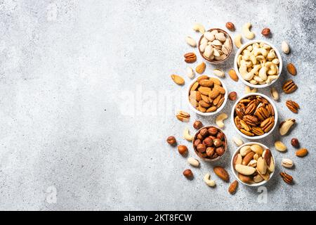 Assortment of nuts in bowls. Cashew, hazelnuts, pecan, almonds, brazilian nuts and pistachios. Stock Photo