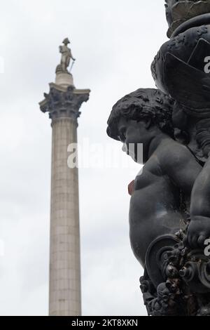 Cast Iron Cherub, Putti On The Side Of A Lamp Post, Street Lamp In Front Of Nelsons Column, Trafalgar Square, London UK Stock Photo