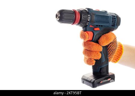 Hand in glove with cordless screwdriver or drill on a white background Stock Photo