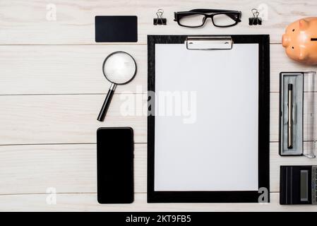 Work from home. Workspace with smartphone, pen, glasses, calculator Stock Photo
