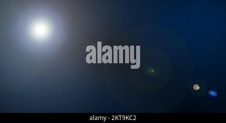 Natural optical lens flare on black background. Sun light leak banner with copy space for text. Stock Photo