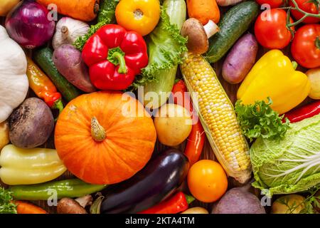 Assortment of the fresh ripe vegetables on wooden background Stock Photo