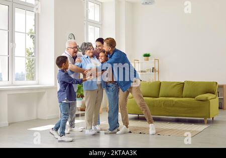 Happy big family hugs their beloved grandmother . Stock Photo