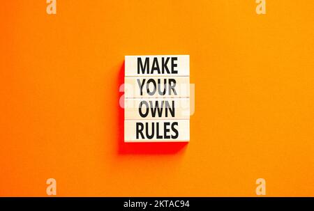 Make your own rules symbol. Concept words Make your own rules on wooden cubes. Beautiful orange table orange background. Business motivational make yo Stock Photo