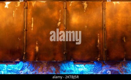 Panoramic grunge rusted metal texture, rust and oxidized metal background. The surface of an old rusty metal ventilation box assembled from segments. Stock Photo