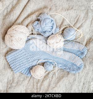 Hand knitted socks,knitting needles and yarn balls. Flat lay. Handmade hobby Stock Photo
