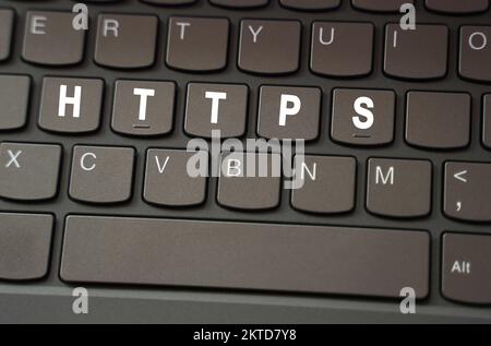 Internet concept. On the black keyboard, the inscription is highlighted in white - HTTPS Stock Photo