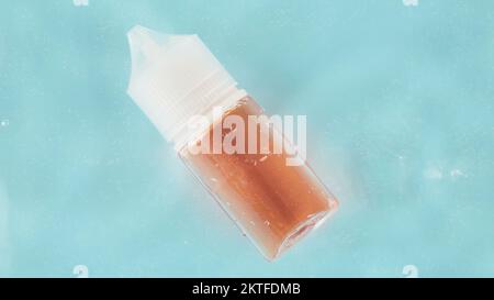 Cosmetic jar . Against the background and glass of water. Blue colour. Facial serum, tonic, moisturizing, freshness. Stock Photo