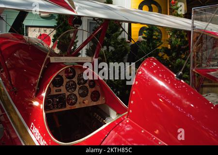 The cockpit of a bright red vintage biplane at the Aviation Museum of New Hampshire. Londonderry, New Hampshire. Stock Photo