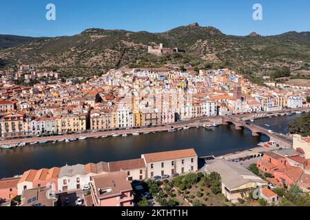 Aerial view of the village of Bosa with colored houses and a medieval castle in the distance on the island of Sardinia in Italy.. Stock Photo