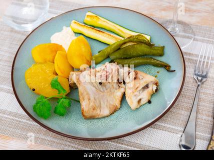 Rabbit meat with vegetables served on plate Stock Photo
