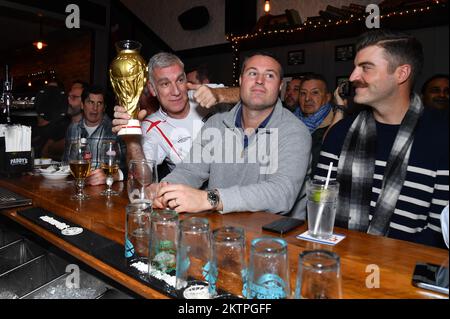 New York, USA. 29th Nov, 2022. British soccer fan Derek Brooker (l) from London England asks a bartender to refill his World Cup shaped been mug at a World Cup watch party during the U.S. vs. Iran game and the Wales vs. UK game, inside The Long Acre Tavern in Times Square, New York, NY, November 29, 2022. The US Men's National Team defeated Iran with a 1-0 win. (Photo by Anthony Behar/Sipa USA) Credit: Sipa USA/Alamy Live News Stock Photo