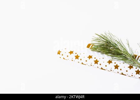 Christmas background. Fir branch and wrapping paper for gifts. minimalistic new year background 2023 Stock Photo