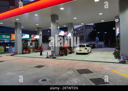 HONG KONG - FEBRUARY 04, 2015: Caltex fuel station at evening. Caltex is a petroleum brand name of Chevron Corporation used in more than 60 countries Stock Photo