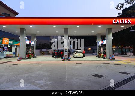 HONG KONG - FEBRUARY 04, 2015: Caltex fuel station at evening. Caltex is a petroleum brand name of Chevron Corporation used in more than 60 countries Stock Photo