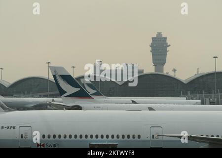 HONG KONG - MARCH, 09, 2015: Cathay Pacific aircraft near boarding bridge. Cathay Pacific is the flag carrier of Hong Kong, with its head office and m Stock Photo