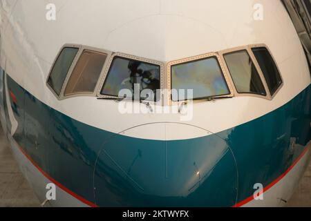 HONG KONG - MARCH, 09, 2015: Cathay Pacific aircraft near boarding bridge. Cathay Pacific is the flag carrier of Hong Kong, with its head office and m Stock Photo