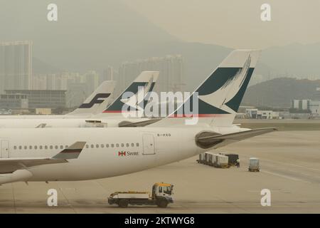 HONG KONG - MARCH, 09, 2015: Cathay Pacific aircraft near boarding bridge. Cathay Pacific is the flag carrier of Hong Kong, with its head office and m Stock Photo