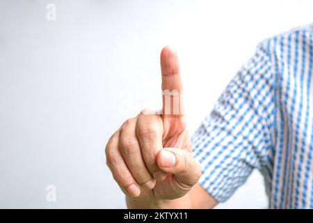 Man index finger pointing up. Touch screen concept. White background. Stock Photo