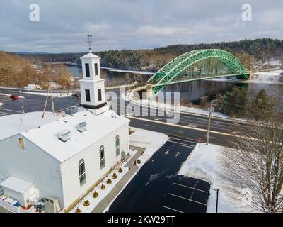 Historic Meeting House and Tyngsboro Bridge on Merrimack River aerial view in winter in town of Tyngsborough, Massachusetts MA, USA. Stock Photo