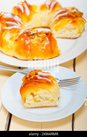 Fresh home baked sweet bread donut cake with almonds and icing sugar on top Stock Photo