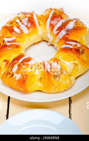 Fresh home baked sweet bread donut cake with almonds and icing sugar on top Stock Photo