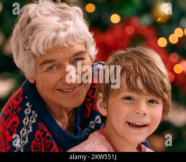 Grandma always visits at christmas. Portrait of a grandmother and her grandson at Christmas. Stock Photo