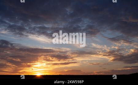 Sunset with multicolored clouds to the horizon Stock Photo