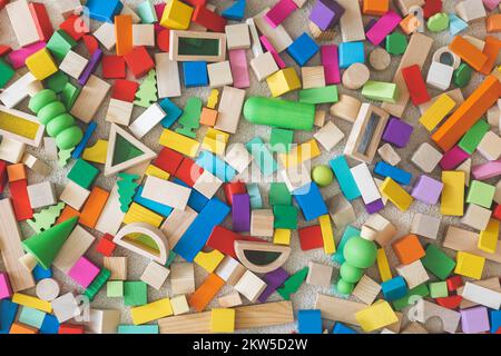 Wooden bricks Montessori materials colored construction details random arrangement seamless pattern Stock Photo