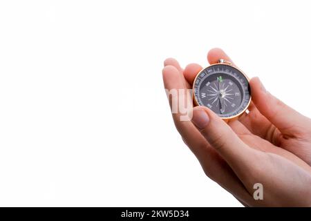 Isolated compass in child's hand on a white background Stock Photo