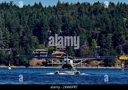 A front view of a float plane taking off on the water on the coast of Vancouver Island in British Columbia Canada. Stock Photo