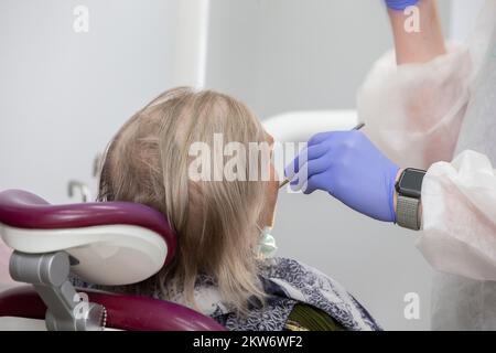 The dentist treats the patient's teeth. Close-up. Stock Photo