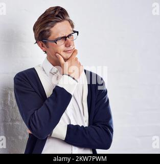 This job frustrates me. A frustrated young man with his hands in his hair. Stock Photo