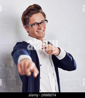 Its all you. A handsome young man pointing towards the camera. Stock Photo