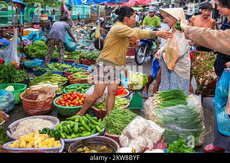 Vietnamese trader working in street market, central Ho Chi Minh City, Vietnam Stock Photo