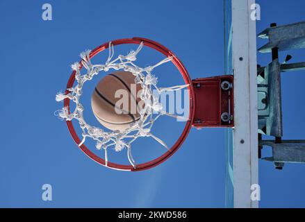 Basketball sports winner throwing, shooting hoops and slam dunk for points, score and performance during sports, competition and game match from below Stock Photo