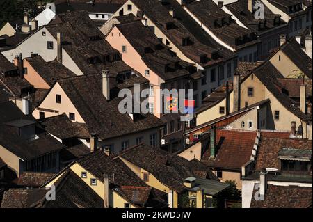 Colourful flags or banners featuring the arms and emblems of the Swiss cantons are strung across the traffic-free streets of the Altstadt or old town of Schaffhausen, beside the High Rhine in northern Switzerland.  The ancient city retains many fine Gothic, Renaissance and Baroque guild or merchant houses with oriel windows and frescoed facades. Stock Photo