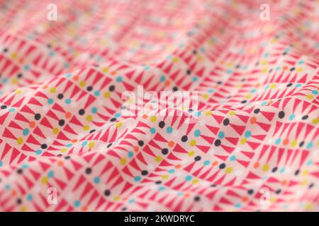 Wavy multicolored fabric with geometric ornament as background. Stock Photo