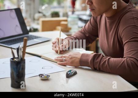 Close up of female artist working on new designs in studio, copy space Stock Photo