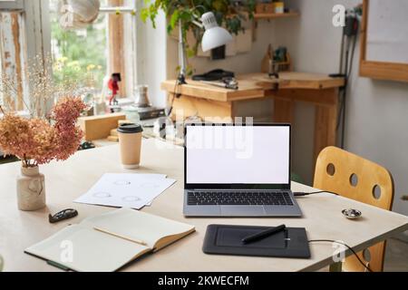 Background image of open laptop with blank screen and graphic tablet on designers workplace, copy space Stock Photo