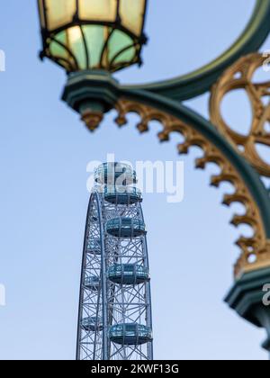 London Eye with street lamps on Westminster Bridge, London, England Stock Photo