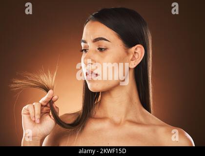 Beauty, woman and hair check for growth of split ends with worried, ponder and thinking face. Concerned skincare, body and hair care model with Stock Photo
