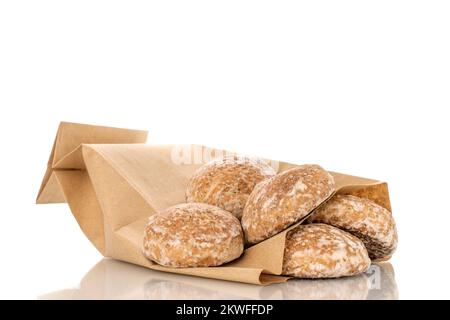 Several sweet tasty gingerbread cookies with paper bag, macro, isolated on white background. Stock Photo