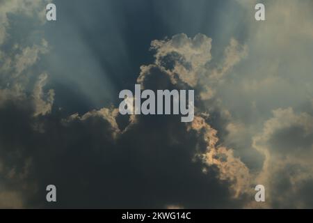 Rays of light shining through dark clouds for background Stock Photo