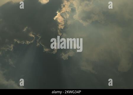 Sun rays bursting through clouds Stock Photo