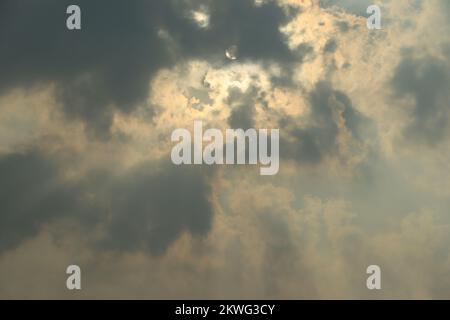 Sun rays bursting through clouds Stock Photo