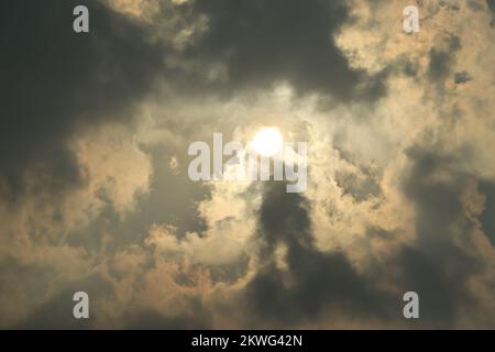 Rays of light shining through dark clouds for background Stock Photo